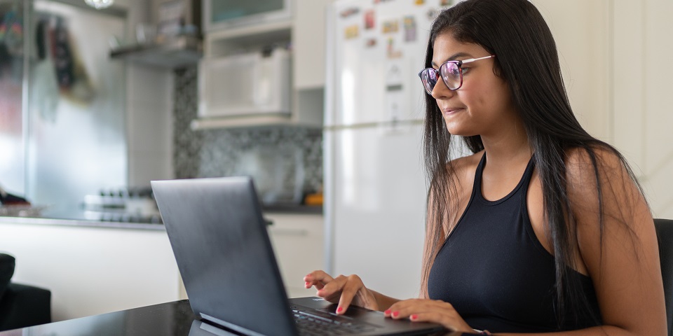 A young woman working at laptop